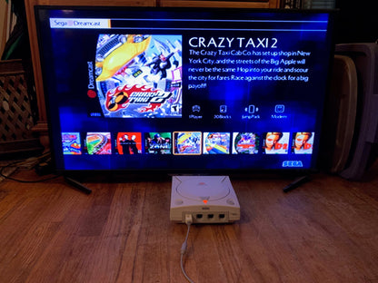 Modded Dreamcast console with GDEMU installed showing 256GB SD card plug and front ports NTSC compatible