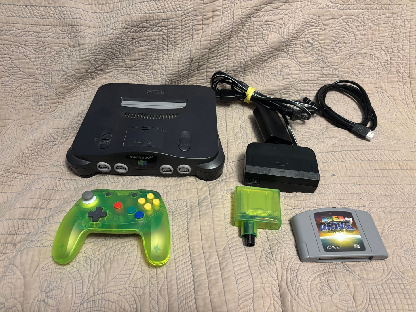 N64 bundle with EverDrive 64 cartridge Retro Fighters controller Pro HDMI adapter and AC cable on white background